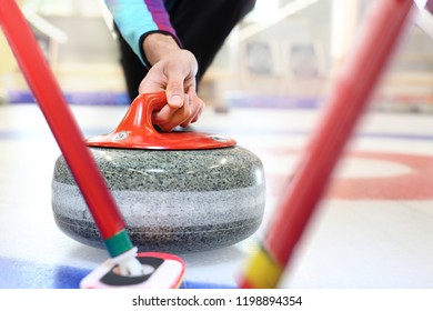 Curling. Players play curling on the curling track.