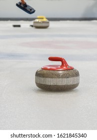 Curling Rocks On A White And Blue Rink