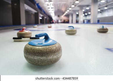Curling stones lined up on the playing field