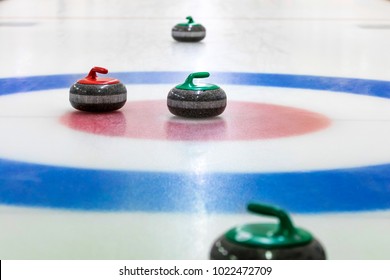 curling stones on the ice