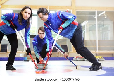 Curling, Team Playing On The Ice.