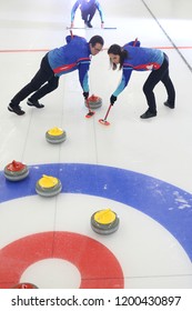 Curling, team playing on the ice.