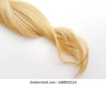 Curls Of Natural Blonde Hair On A White Background.