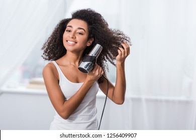 Curly Beautiful African American Girl Drying Hair At Home