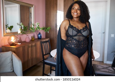 Curly Black Afro Woman Stand Indoors, In Underwear And Silk Dressing Gown. Newly Awakened Woman Has Happy Morning