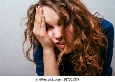 Curly Girl Feeling Unwell. Gray Background.