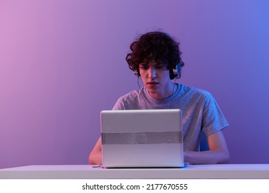 Curly Guy Sitting At The Table Gaming Laptop Isolated Background