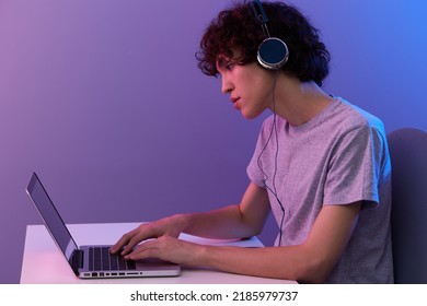 Curly Guy Sitting At The Table Gaming Laptop Isolated Background