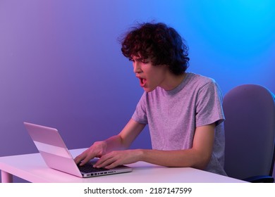 Curly Guy Sitting At The Table Gaming Laptop Isolated Background