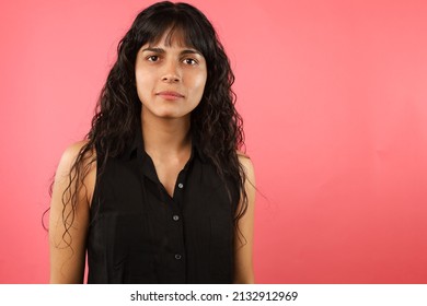 Curly Hair Girl With Black Button Down Blouse, On Pink Background With Serious Face, Women's Day Concept