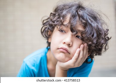 Curly Hair Mixed Kid Is Getting Bored Of Waiting Or Something With Toned Color And Selective Soft Focus