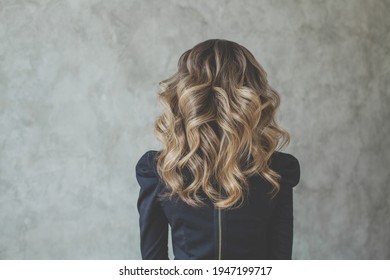 Curly hair. Perfect woman back and head with curly hairdo
