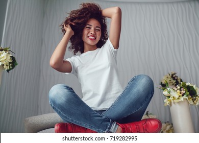Curly haired girl with freckles in blank white t-shirt. Mock up.