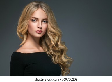 Curly long hair blonde young model. Beauty girl with curly perfect hairstyle