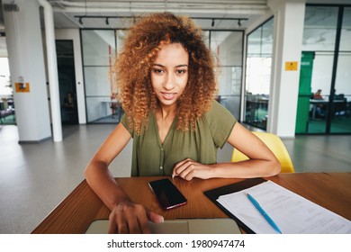 Curly woman setting everything up for a video-call