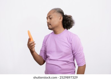 curly-haired adult male wants to eat fresh carrots, healthy lifestyle concept, isolated white background. - Powered by Shutterstock