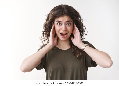 Curly-haired Armenian Girl Distracted Disturbed Awful Unbearable Loud Noise Covering Ears Yelling Asking Turn Down Sound Volume, Standing Bothered Cannot Work Crowded Place, White Background