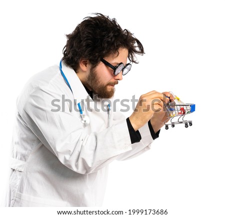 curly-haired doctor with funny glasses holds a small cart with medicines. close-up