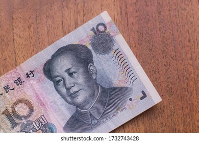 The Currency of the China - Close up of a blue ten remminbi or yuan note on a brown table background. Money exchange. - Shutterstock ID 1732743428