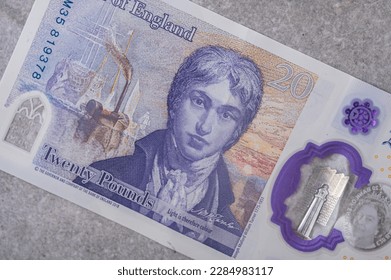 Currency of Great Britain (England) pound. Banknotes with a denomination and 20 portrait of Joseph Mallord William Turner on a gray background