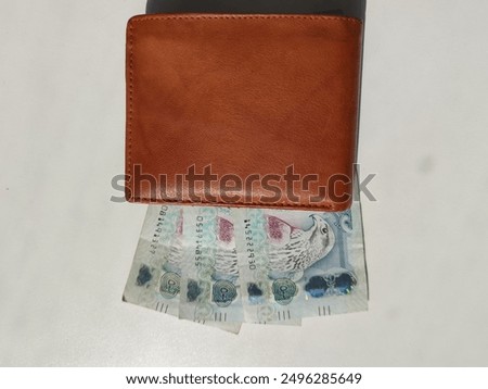 Currency notes, UAE Emirates currency 500 aed Dirhams, Closeup of UAE Five Hundred dirhams currency notes, paper money 500 aed dirhams.
Brown leather wallet with 500 dirhams banknotes, UAE Emirati 500