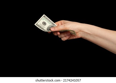 Currency On The Black Market. The Right Hand Holds A Hundred Dollar Bill On A Black Background



