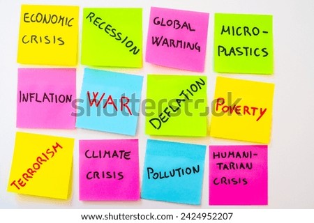 Current affairs, sheets of various colors with words: economic crisis, war, inflation, terrorism, etc., on a black background.
