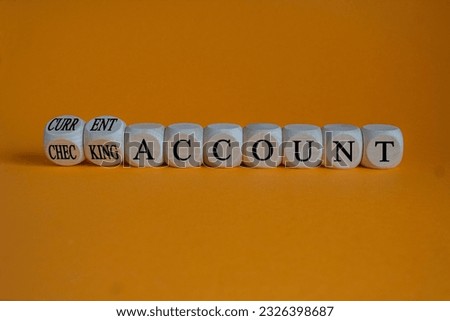 Current or checking account symbol. Turned wooden cubes and changed words 'checking account' to 'current account'. Beautiful orange background, copy space. Business concept.