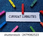 Current liabilities writting on blue background.