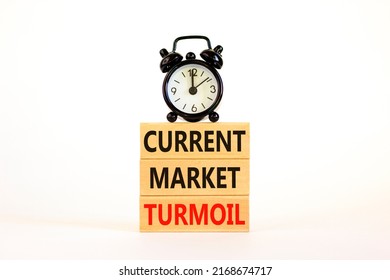 Current market turmoil symbol. Concept words Current market turmoil on wooden blocks on a beautiful white table white background. Black alarm clock. Business, finacial current market turmoil concept.