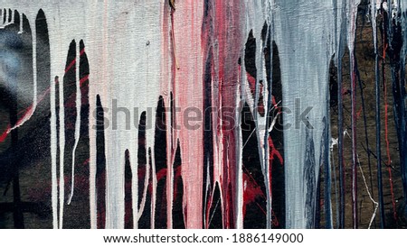The current paint on a dark background. Dripping  abstract structure of pouring. Brooks of liquid colorful. Paint dripping wall.