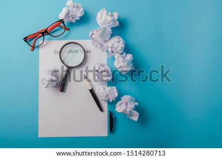 Curriculum vitae written on an blank white paper on blue background
