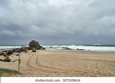 Currumbin, Gold Coast, Australia December 13 2020 Council workers putting up beach closed warning signs as a large storm passes through bring rain, wind and large swells at Currumbin Rocks Australia
