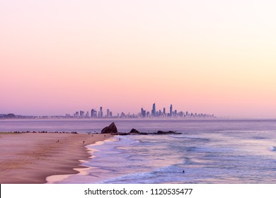 Currumbin Rock with the Gold Coast skyline at sunrise with a pink sky