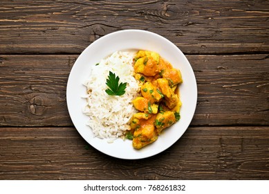 Curry Chicken With Rice On Plate Over Wooden Background. Top View, Flat Lay.