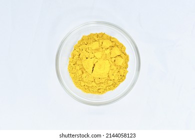 Curry Powder In Glass Bowl On White Background