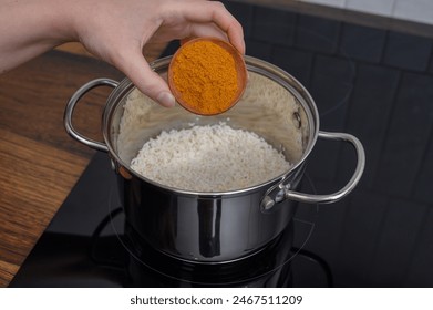 Curry rice, curry spice with turmeric added to a pot of boiling rice - Powered by Shutterstock