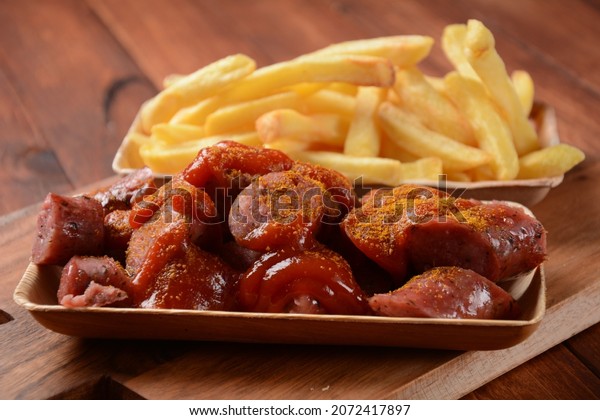 Currywurst\
Sausages with French fries. Traditional German currywurst  sausages\
with Curry spice on wursts served with\
pommes.