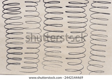 cursive or spiral lines arranged in rows on brown paper