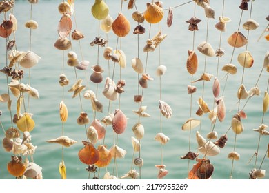 Curtain crafted from seashells. Shell curtain mobile in a house by the sea.  - Shutterstock ID 2179955269