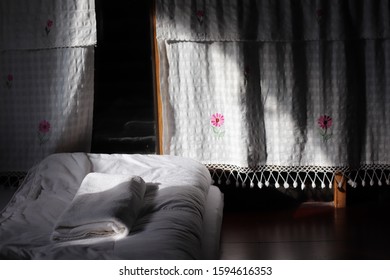 A curtain with flowers pattern and its shadow