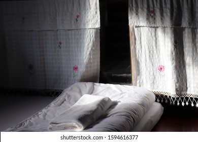 A curtain with flowers pattern and its shadow