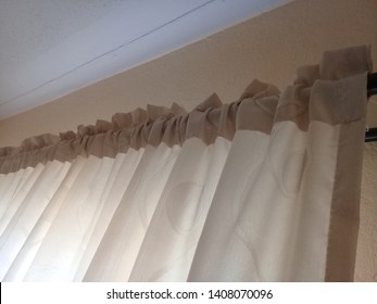 A Curtain Rod That Is Hanging A Gold Curtain. Interior Decoration With Gold Curtains. Window Covering Design.