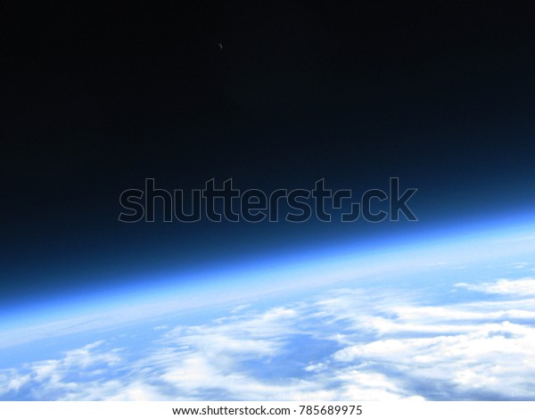 Curvature of\
the earth and crescent moon in single shot taken from a high\
altitude balloon flight to the\
stratosphere