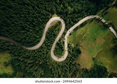 Curve asphalt road on mountain forest summer.	
Aerial view of the road passing through the mountain and green forest.  - Powered by Shutterstock