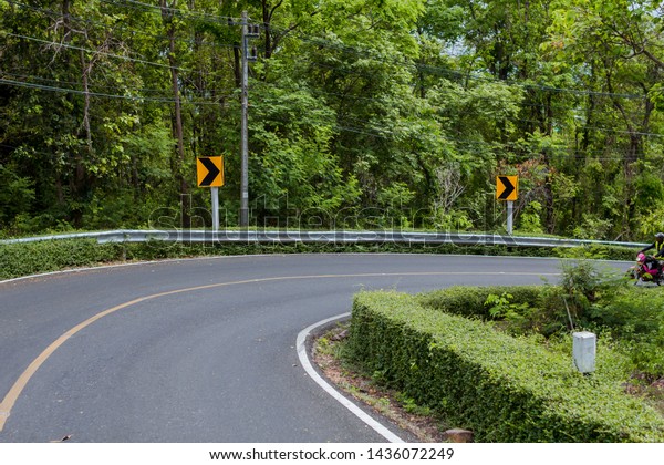Curve in the forest,\
Bend street up to the mountain, Traffic warning sign label for show\
that the road curves 