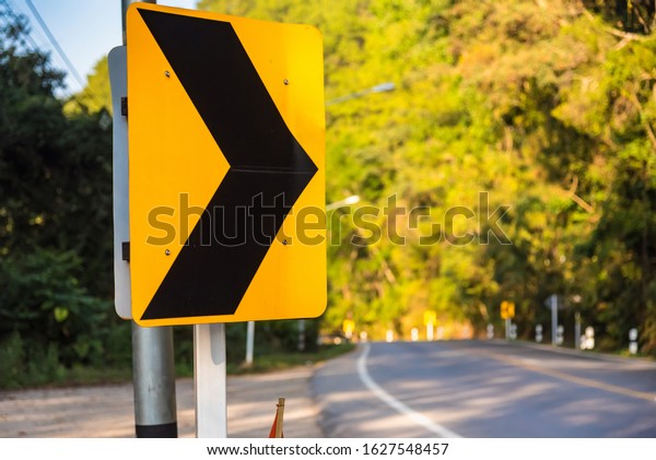 Curve in the forest,\
Bend street up to the mountain, Traffic warning sign label for show\
that the road curves