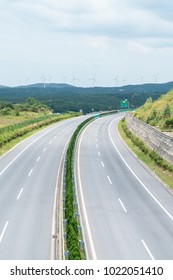 Curve Highway Background With Wind Farm