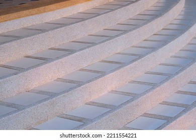 Curve Line Pattern Of Exposed Aggregate Finish Cobblestone With White Tile Floor Of Vintage Staircase