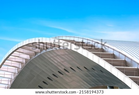 Curve Metal Roof of Modern Building against blue sky background